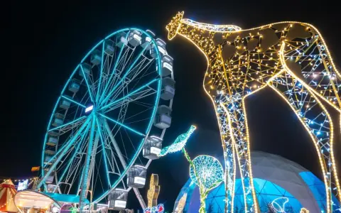 Leuchtende Giraffe und Riesenrad auf einem Jahrmarkt, perfekt für Winterferien Thüringen 2026.